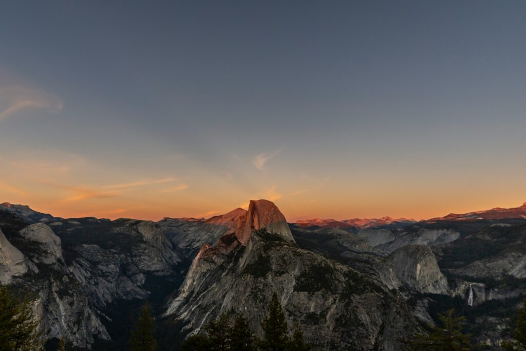 Half dome mountain illuminated by sunset light