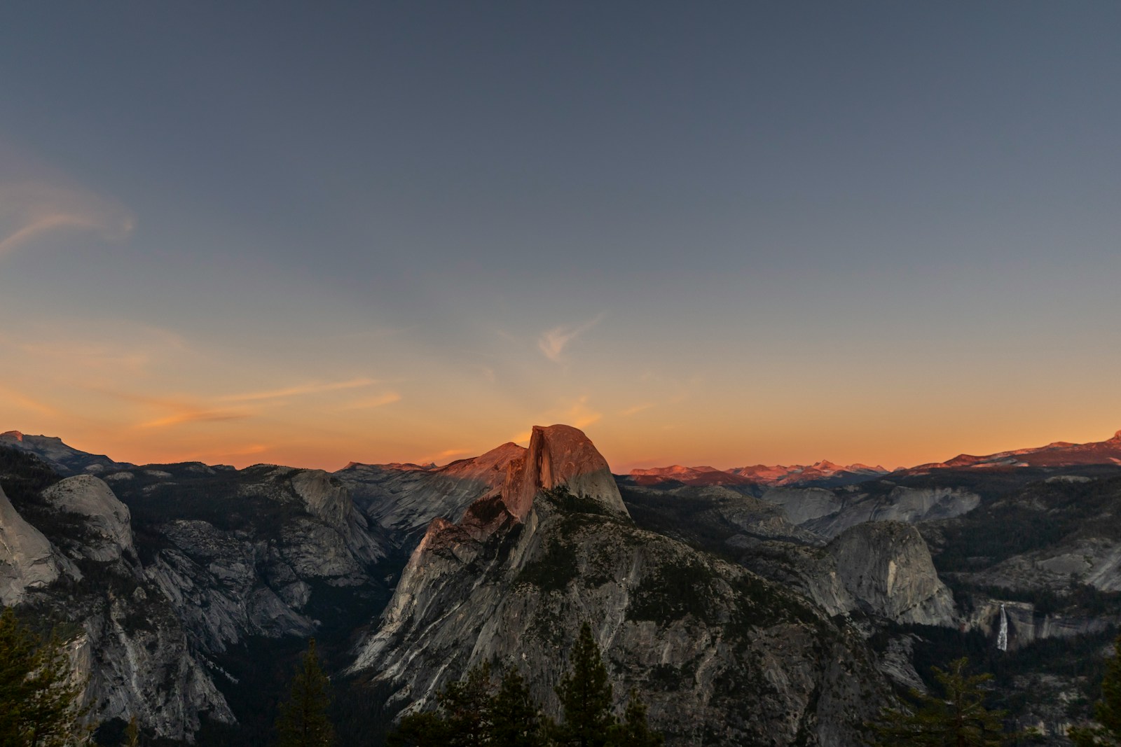 Half dome mountain illuminated by sunset light